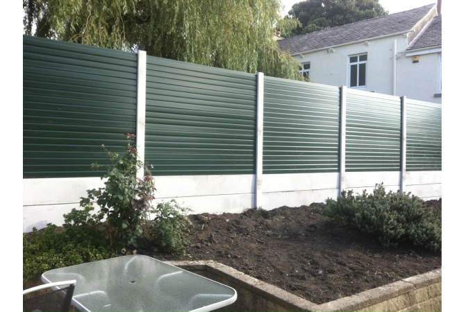 Green upvc fencing, complete with concrete posts and bases