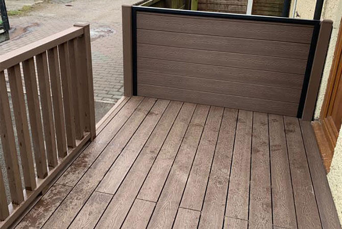 Chocolate composite decking to the rear of a property.