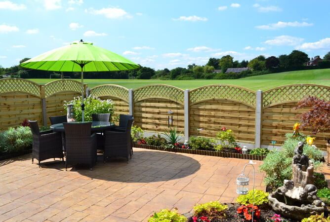 Arched lattice top continental fence panels with concrete posts & bases