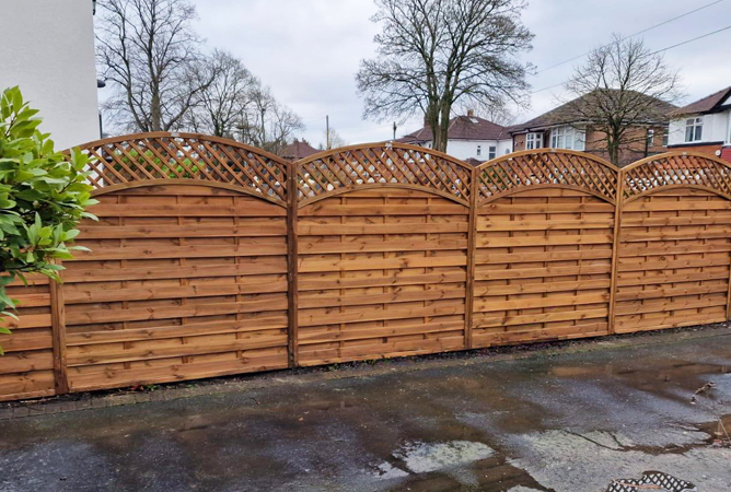 Arched lattice top fence panels treated in our summer tan preservative