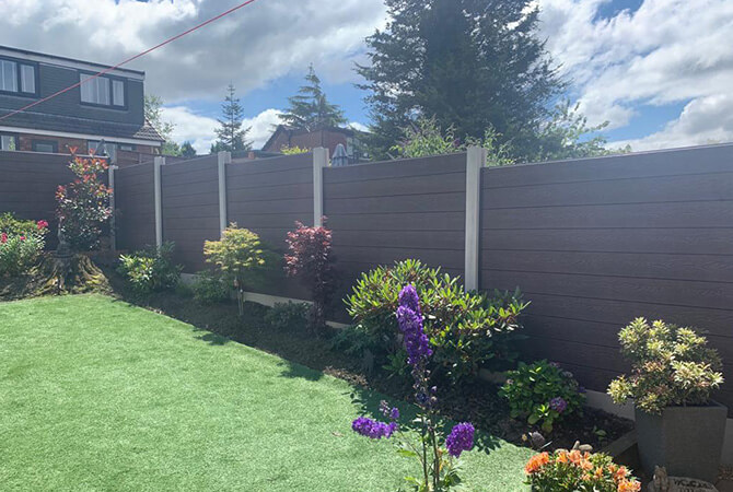Chocolate coloured composite fencing in concrete posts
