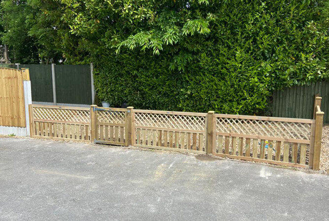 Cross top fencing and gate creating a small fenced off area