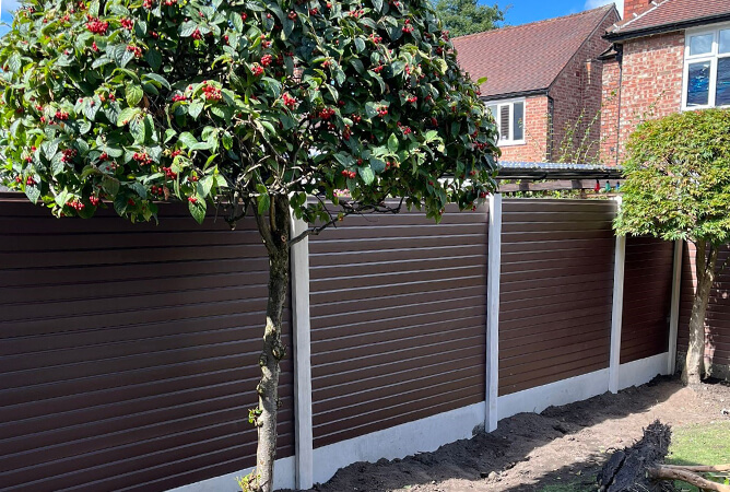Gloss UPVC brown fencing in brand new concrete posts & bases