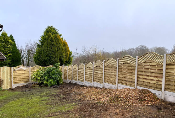 Omega lattice top fence panels with concrete posts and bases