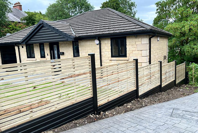 Slatted lattice with black foil wrapped posts and bases