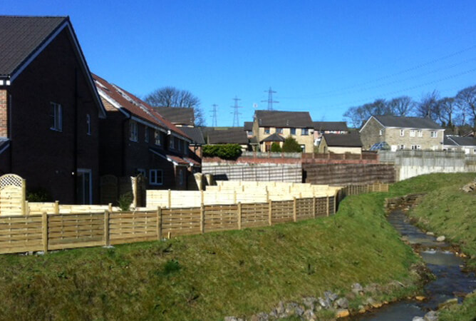 Square horizontal fence panels along a river