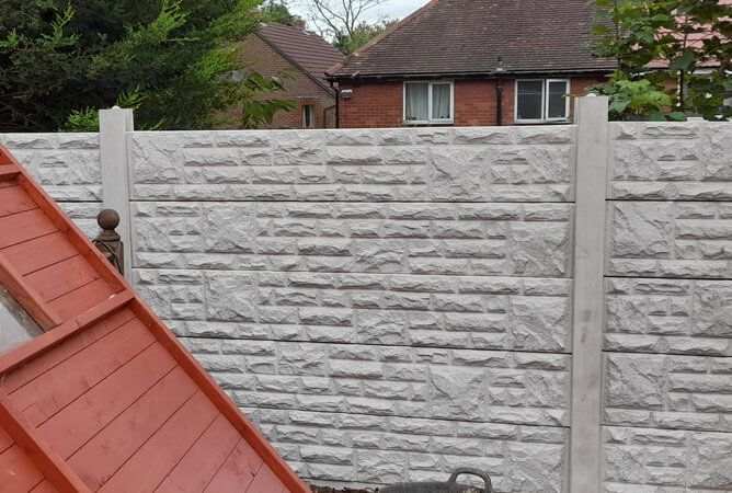 Rock faced bases make up a fence panel