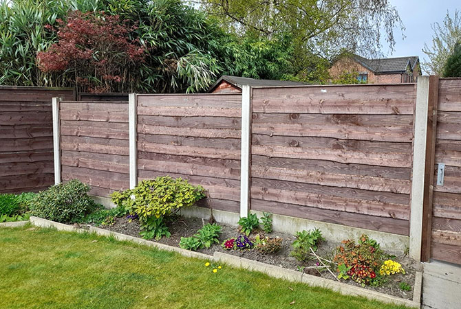 super duty waney lap fence panels in new concrete posts and bases