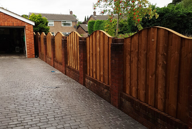 Turret Fence Panels With An Omega Top Between Brick Pillars