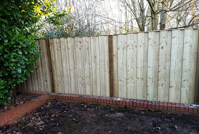 Pressure treated turret fence panels with wooden posts