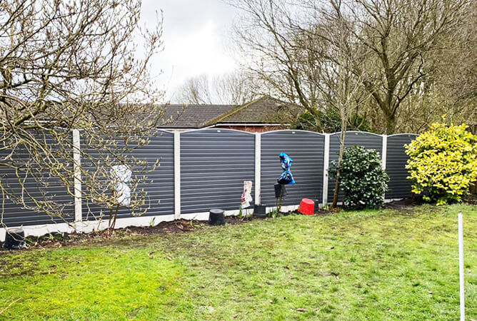 Carbon grey composite upvc fence with a bowed top