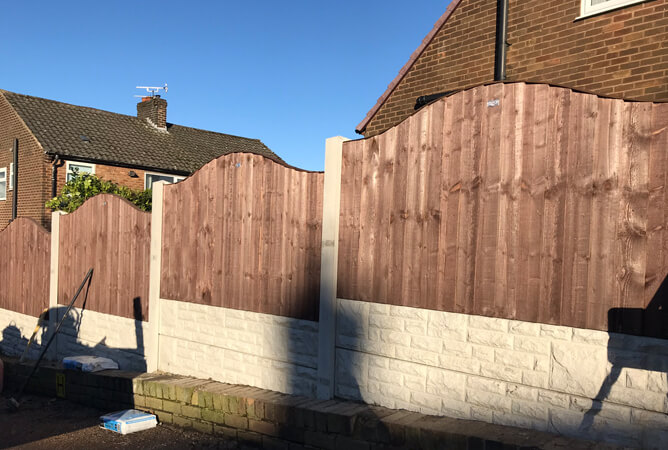 Vertical lap fence panels with an omega top