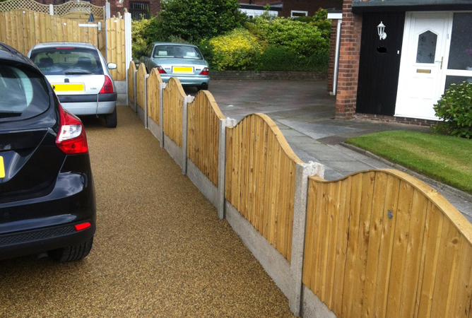vertical lap fence panels in new concrete posts and bases