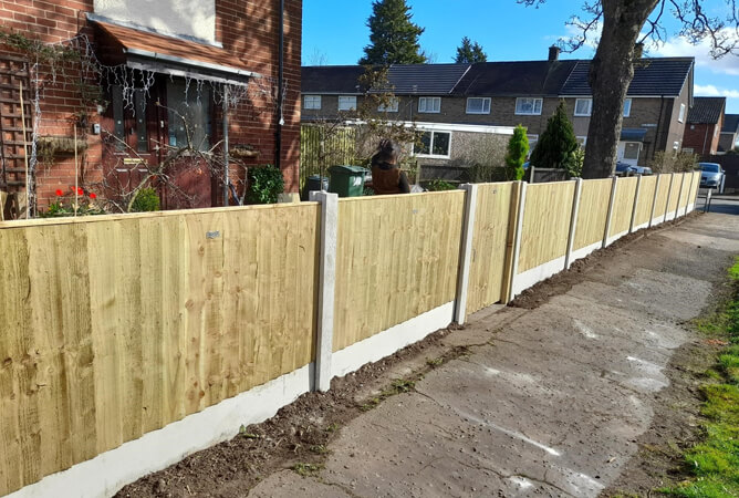 Pressure treated vertical lap fencing & gate with concrete posts and bases
