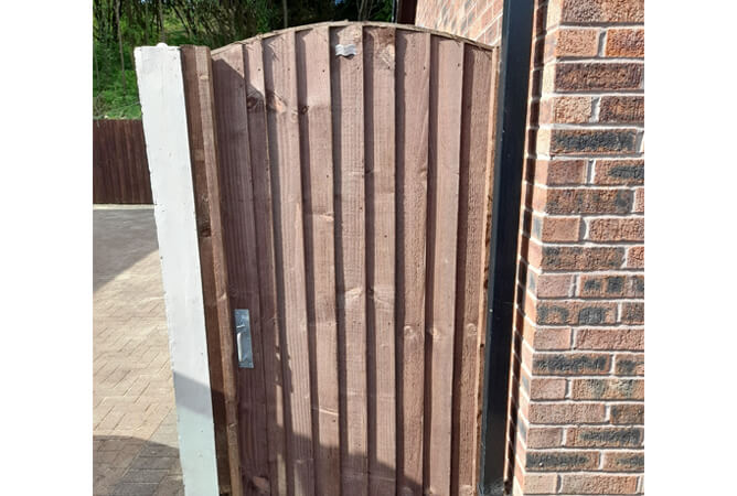 Vertical lap garden gate with an arched top
